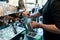 Hand of a barista holding a stainless mug