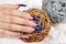 Hand with beautiful long artificial blue french manicured nails