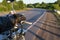 The hand of the biker on the control handle of the motorcycle and the view of the road