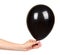 Hand with black inflateble balloon, party event decoration, glossy ball