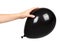 Hand with black inflateble balloon, party event decoration, glossy ball