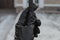 A hand in a black leather glove holds a metal fence