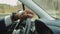 Hand of black male driver holding steering wheel during driving