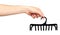 Hand with black plastic clothes hanger. Isolated background