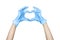 Hand in a blue latex disposable glove showing Heart sign isolated on white background