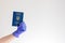 Hand in blue medical glove holding ukrainian passport. Travel restrictions, medicine, quarantine and COVID-19 coronavirus pandemic