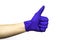 Hand in blue rubber protective medical surgical glove on the white background hand clenched fist thumb raised up