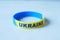 Hand with blue and yellow wristband , colors of flag of Ukraine.