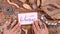 Hand with BOHEMIAN handwritten card over a wooden table top view