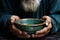 Hand and bowl old mans grasp on emptiness illustrates the concept of poverty