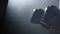 Hand of boxer and punching bag over black background. Male boxer boxing in punching bag. Young muscular boxer exercising