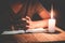 Hand boy praying In the room and lit candles to light , Hands folded in prayer concept for faith, spirituality and religion