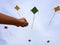 Hand of a boy raises a kite in a sky