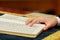 Hand of boy reading the Jewish Torah at Bar Mitzvah