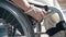 Hand Brake system of wheelchair for safety. Woman blocking wheel of the wheelchair, close-up view. Wheelchair brake.