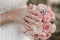 Hand of the bride with a ring holds a wedding bouquet. Wedding decorations.  The bride`s bouquet