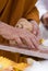 Hand of Buddhist monk painting religious symbols