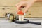 Hand building small wooden house from colourful small pieces