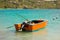 A hand-built wooden vessel with an outboard engine at friendship bay