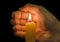 Hand and burning candle