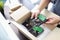 Hand of business man holding Harddisk for PC and Bubble Wrap or Bubble sheet for Wrapping near parcel box on black desk in home