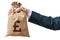 Hand of business man holds bag full of money with British pound