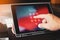 Hand of business man tying tablet computer with password login on screen at office, selective focus