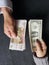 hand of business man and woman exchanging russian banknotes and american dollars bills