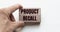 Hand of a businessman holding wooden blocks. Conceptual image. Text PRODUCT RECALL concept business succeed