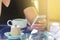 Hand of Businessman or Male use Wireless Smartphone with Cup of