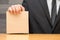 Hand of businessman showing brown book