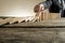 Hand of businessman stopping falling domino pieces