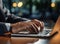 Hand of businessman wearing a suit. Typing details on keyboard keys about the business. Generative AI