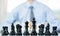 hand of businessmen moving chess in competition shows leadership, followers and business success strategies