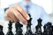 hand of businessmen moving chess in competition shows leadership, followers and business success strategies