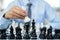 hand of businessmen moving chess in competition shows leadership, followers and business success strategies