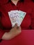 hand of a businesswoman holding singaporean banknotes