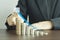 hand of businesswomen points arrow on pile of coins