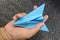 Hand carefully holding model plane. Concept of airplane industry, safety, security and insurance.