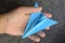 Hand carefully holding model plane. Concept of airplane industry, safety, security and insurance.