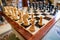 Hand-carved chess pieces and board seen within a private house.