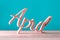 Hand carved wooden letters as April word. 1st day of april concept