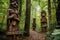 hand-carved wooden tribal statues in a forest setting