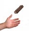 Hand catching a chocolate bar
