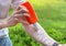 Hand of caucasian man applying sun cream & x28;sunscreen& x29; from a plastic container.