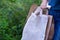 Hand of caucasian man holding eco friendly white cloth bag and paper bags for organic shopping. Zero waste.