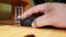 Hand of a Caucasian man working with the mouse on a wooden table, remote work, freelancer, workplace