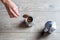 Hand of caucasian woman adding ground coffee to italian moka pot.