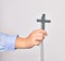 Hand of caucasian young catholic woman holding christian cross over isolated white background