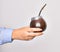 Hand of caucasian young woman holding mate infusion over isolated white background